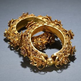 A pair of silver filigree gilt bracelets