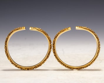 A pair of copper-gilt bracelets