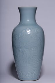 A Qing Dynasty sky blue glaze dark engraved dragon pattern appreciation bottle