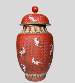 A Qing Dynasty red glazed carved porcelain bat lantern jar