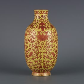 A small plum bottle made in the year of Qianlong in the Qing Dynasty with yellow ground alum red