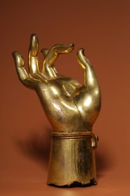 A Qing Dynasty bronze gilt Buddha hand ornament