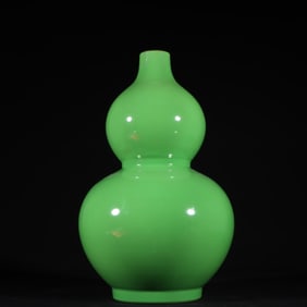 A Qing Dynasty Qianlong green glazed gourd bottle