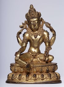 A Qing Dynasty bronze gilt four-armed Guanyin seated statue