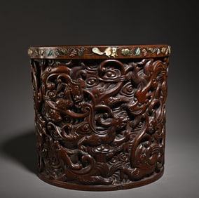 A Qing Dynasty Huanghuali carved landscape dragon pen holder