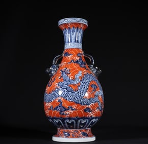 A Ming Dynasty Xuande blue and white alum red cloud dragon pattern animal ear bottle
