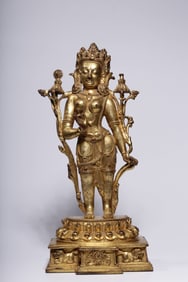 A bronze gilt statue of Guanyin holding a lotus in the Qing Dynasty