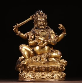 A Ming Dynasty bronze gilt four-armed Magala statue