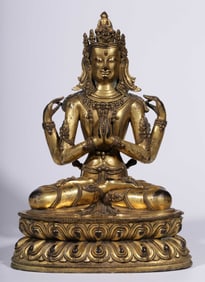 A Qing Dynasty bronze gilt four-armed Guanyin seated statue