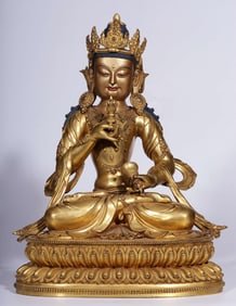 A Qing Dynasty bronze gilt Vajrasattva hammer seated statue