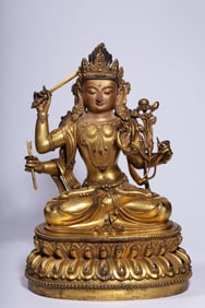 A Qing Dynasty bronze gilt four-armed statue of Manjushri Bodhisattva
