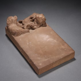 A stone carving of a lion inkstone