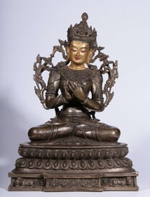 A Qing Dynasty bronze gilt silver painted gold face inlaid with gems Manjushri sitting statue