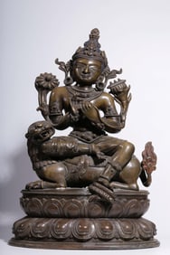 A Qing Dynasty two-color alloy bronze wrong silver riding roar Guanyin seated statue
