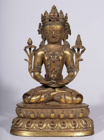A Qing Dynasty bronze gilt seated statue of a long-lived Buddha