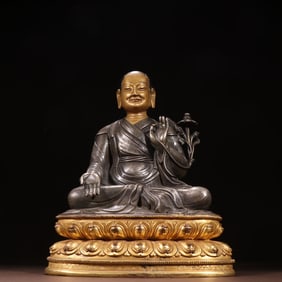 A Qing Dynasty Tibetan bronze gilt inlaid sterling silver patriarch statue
