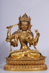 A Qing Dynasty bronze gilt four-armed Guanyin seated statue