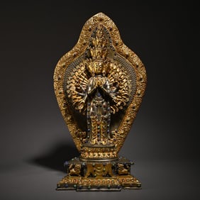 An old Tibetan bronze gilt thousand-armed Guanyin study ornament