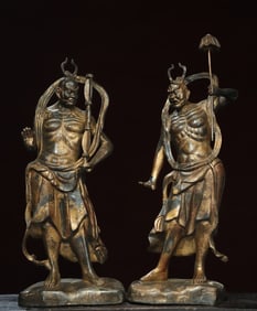 A pair of bronze and gold statues