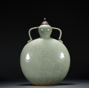 A piece of Song Yue kiln celadon carved boy holding the moon flat bottle