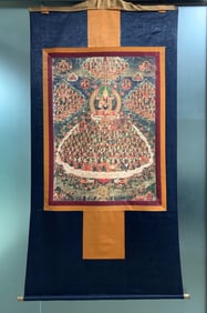 A Tibetan Gelugpa lama makes offerings to the grain field thangka