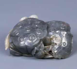 A late Qing Hetian jade blue and white seed material lotus pod carving