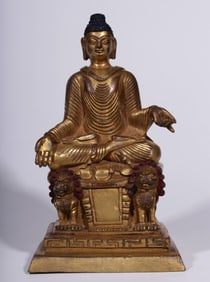 A Qing Dynasty bronze gilt Swat style seated statue of Baosheng Buddha