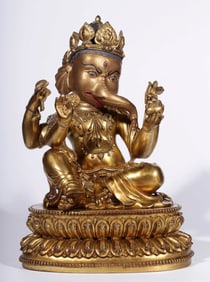 A Ming Dynasty "Ming Yongle Nianshi" bronze gilt elephant trunk God of Wealth statue
