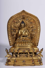 A Qing Dynasty bronze gilt immovable Buddha backlit statue