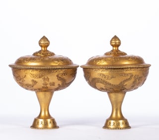 A pair of gilt copper cups