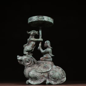 A bronze piece of the Hu man riding the beast candlestick