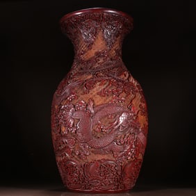 A Qing Dynasty red carved dragon and phoenix pattern bottle