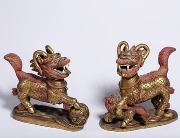 A pair of Qing Dynasty bronze gilt unicorn ornaments