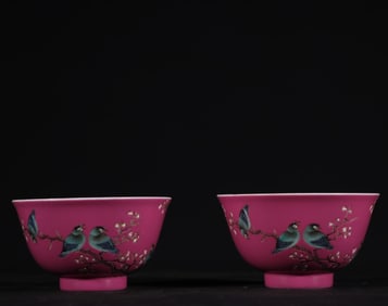 A pair of Qing Dynasty Qianlong carmine ground pastel flower and bird cups