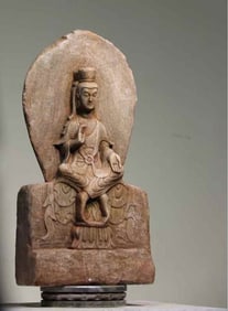 A white marble backlit seated Buddha