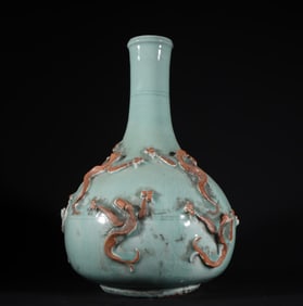 A piece of Longquan kiln powder and blue glaze pile carved dragon pattern bottle in the Yuan Dynasty