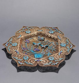 A piece of clear silver filigree dotted emerald flower mouth plate