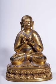 A Qing Dynasty bronze gilt silver seated statue of Guru Marpa