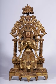 A Qing Dynasty bronze gilt backlit seated statue of the future Buddha