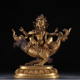 A Qing Dynasty bronze gilt four-armed Guanyin statue