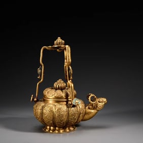 A bronze gilt sheep's head beam jug