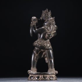 A Qing Dynasty black stone statue of the Buddha of Huanxi