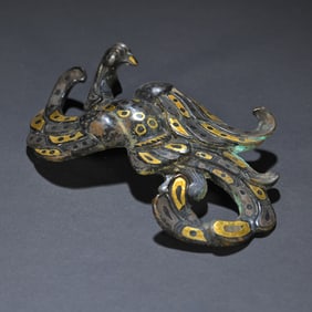 A piece of wrong gold and silver with a hook