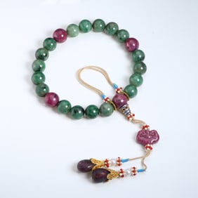 A piece of Fei Cui is held by the eighteen sons