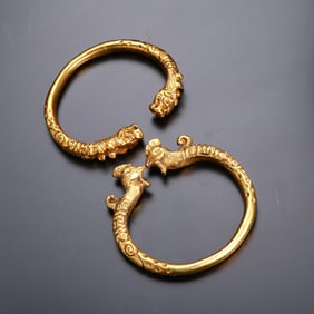 A pair of bronze gilt dragon and phoenix bracelets