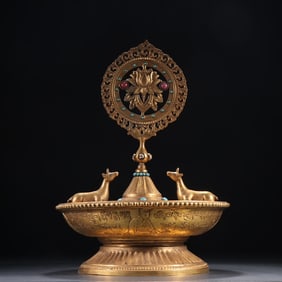 A seated statue of a bronze gilt green Tara from the Qing Dynasty