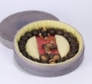 A late Qing old agarwood inlaid with silver gilt eighteen sons held