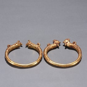 A pair of bronze gilt crested bracelets