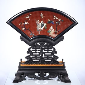 A piece of wood carving with a treasure embedded in the interstitial story of the characters