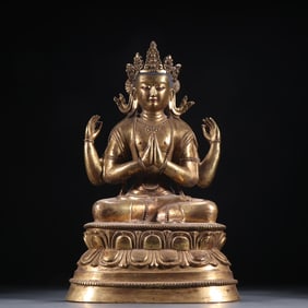 A bronze gilt four-armed statue of Guanyin